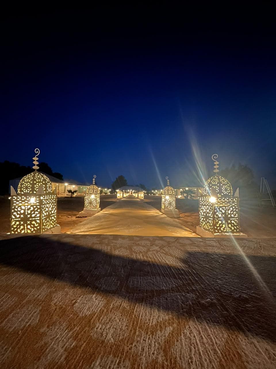 Lantern-lit desert camp at night